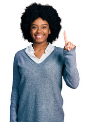 Sticker - Young african american woman wearing business clothes showing and pointing up with finger number one while smiling confident and happy.