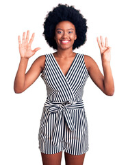 Sticker - Young african american woman wearing casual clothes showing and pointing up with fingers number eight while smiling confident and happy.