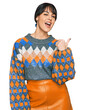 © Krakenimages.com - Young hispanic woman wearing casual clothes smiling with happy face looking and pointing to the side with thumb up.