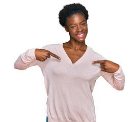 Poster - Young african american girl wearing casual clothes looking confident with smile on face, pointing oneself with fingers proud and happy.