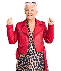 Wall Mural - Senior beautiful woman with blue eyes and grey hair wearing a modern style with a red leather jacket screaming proud, celebrating victory and success very excited with raised arms