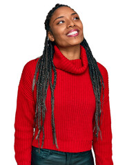 Wall Mural - African american woman wearing casual winter sweater looking away to side with smile on face, natural expression. laughing confident.