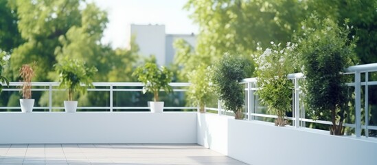 Wall Mural - Contemporary balcony with white residential or hotel railing. Cozy outdoor space with green surroundings.