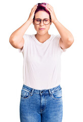 Sticker - Young beautiful woman with pink hair wearing casual clothes and glasses suffering from headache desperate and stressed because pain and migraine. hands on head.