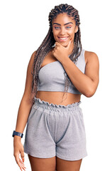 Poster - Young african american woman with braids wearing sportswear looking confident at the camera smiling with crossed arms and hand raised on chin. thinking positive.