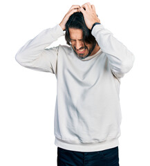 Canvas Print - Middle age caucasian man wearing casual clothes suffering from headache desperate and stressed because pain and migraine. hands on head.