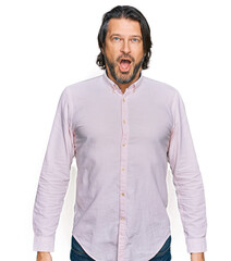 Poster - Middle age handsome man wearing business shirt afraid and shocked with surprise expression, fear and excited face.