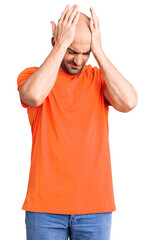 Wall Mural - Young handsome man wering casual t shirt suffering from headache desperate and stressed because pain and migraine. hands on head.