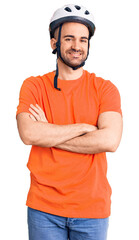 Canvas Print - Young handsome man wearing bike helmet happy face smiling with crossed arms looking at the camera. positive person.