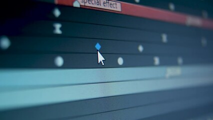 Working in animation software Camera macro shot of a computer screen display. Shot of a computer screen in video editing software. Moving keyframes of film. Low depth of field. 