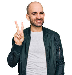 Poster - Young hispanic man wearing casual clothes showing and pointing up with fingers number two while smiling confident and happy.