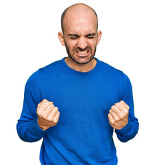 Canvas Print - Young hispanic man wearing casual clothes very happy and excited doing winner gesture with arms raised, smiling and screaming for success. celebration concept.