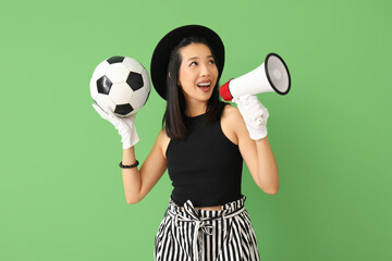 Sticker - Female Asian football fan with megaphone on green background