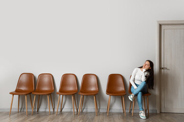 Canvas Print - Young woman waiting for her turn in room