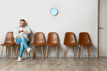 Canvas Print - Mature man waiting for his turn in room