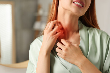 Sticker - Suffering from allergy. Young woman scratching her neck in bathroom, closeup. Space for text