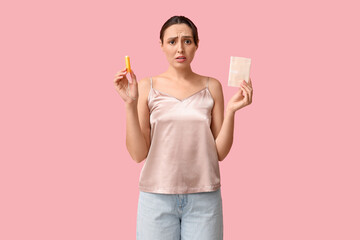 Sticker - Beautiful young woman with tampon and menstrual pad on pink background