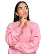 © Krakenimages.com - Young asian woman wearing casual winter sweater with hand on chin thinking about question, pensive expression. smiling and thoughtful face. doubt concept.
