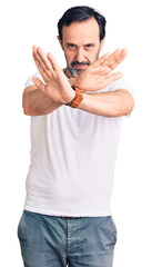 Sticker - Middle age handsome man wearing casual t-shirt rejection expression crossing arms and palms doing negative sign, angry face