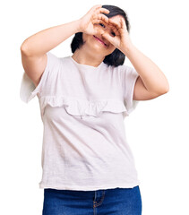 Sticker - Brunette woman with down syndrome wearing casual white tshirt doing heart shape with hand and fingers smiling looking through sign