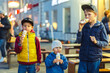 Happy brothers enjoy tasty ice cream together in city