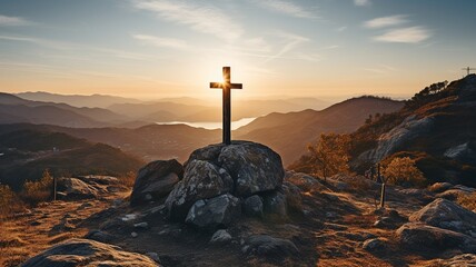 Cross atop a mountain with a sunset in the backdrop. .