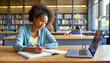 © LynnC - Young female student studying in the library. She is using a laptop and learning online