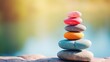 © Artyom - A balanced stack of multicolored stones against a soft backdrop