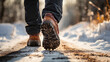 Close up of man walking on winter road with ice and snowflakes