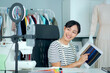 © DG PhotoStock - Happy cheerful Asian beautiful woman showing her works on social network live steaming video.