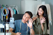 © DG PhotoStock - Designer showing their works on social network live steaming. Couple selling clothes on social media.