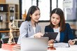 © NanSan - Two middle aged and young Asian lawyer in a formal suit consoles a client during a legal consultation, with a gavel and documents on the table.
