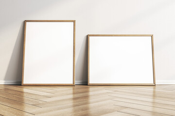 Poster - Empty white photo frames leaning on concrete wall in interior with wooden flooring. Mock up, 3D Rendering.