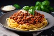 A plate of spaghetti bolognese topped with grated