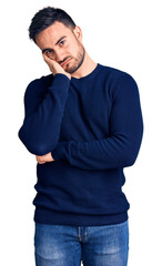 Wall Mural - Young handsome man wearing casual clothes thinking looking tired and bored with depression problems with crossed arms.