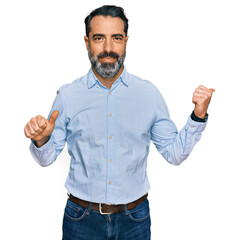 Sticker - Middle aged man with beard wearing business shirt pointing to the back behind with hand and thumbs up, smiling confident