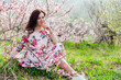 © dmitriisimakov - travel walk beautiful brunette woman in flowering trees spring nature
