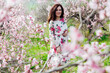 © dmitriisimakov - spring nature travel walk beautiful woman brunette in flowering trees
