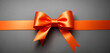 Orange gift ribbon with bow isolated on gray background. Decorative Orange bow with horizontal ribbon. bow for page decor isolated on grey.