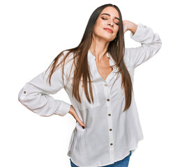 Wall Mural - Young beautiful woman wearing casual white shirt suffering of neck ache injury, touching neck with hand, muscular pain