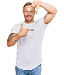 Wall Mural - Young irish man wearing casual clothes smiling making frame with hands and fingers with happy face. creativity and photography concept.