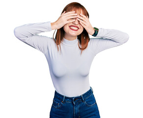 Wall Mural - Redhead young woman wearing casual turtleneck sweater covering eyes with hands smiling cheerful and funny. blind concept.