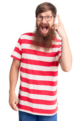 Sticker - Handsome young red head man with long beard wearing casual clothes pointing finger up with successful idea. exited and happy. number one.