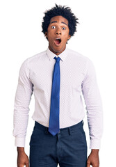 Poster - Handsome african american man with afro hair wearing business clothes scared and amazed with open mouth for surprise, disbelief face