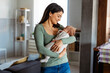 © NDABCREATIVITY - Pretty woman holding a newborn baby in her arms. Single mother parent concept.