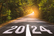 The New Year 2024 Or Straightforward Concept. Text 2024 Written On The Long Road In The Forest. Planning And Challenge, Business Strategy, Opportunity, Hope, And New Life.	