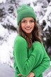 © forma82 - Beautiful brunette in green hat in snowy forest.