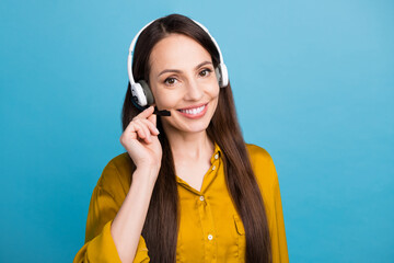 Wall Mural - Photo of good mood shiny woman dressed yellow shirt talking microphone listening headphones empty space isolated blue color background