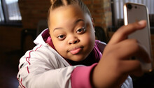 African American Black Teenage Girl With Down Syndrome Taking Selfie On Mobile Phone. Beautiful Portrait Of Girl Having Fun With Smartphone Taking Photos Or Making A Video For Social Media Disability