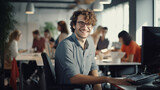Fototapeta  - Cool worker with glasses smiling at the camera in a busy office
